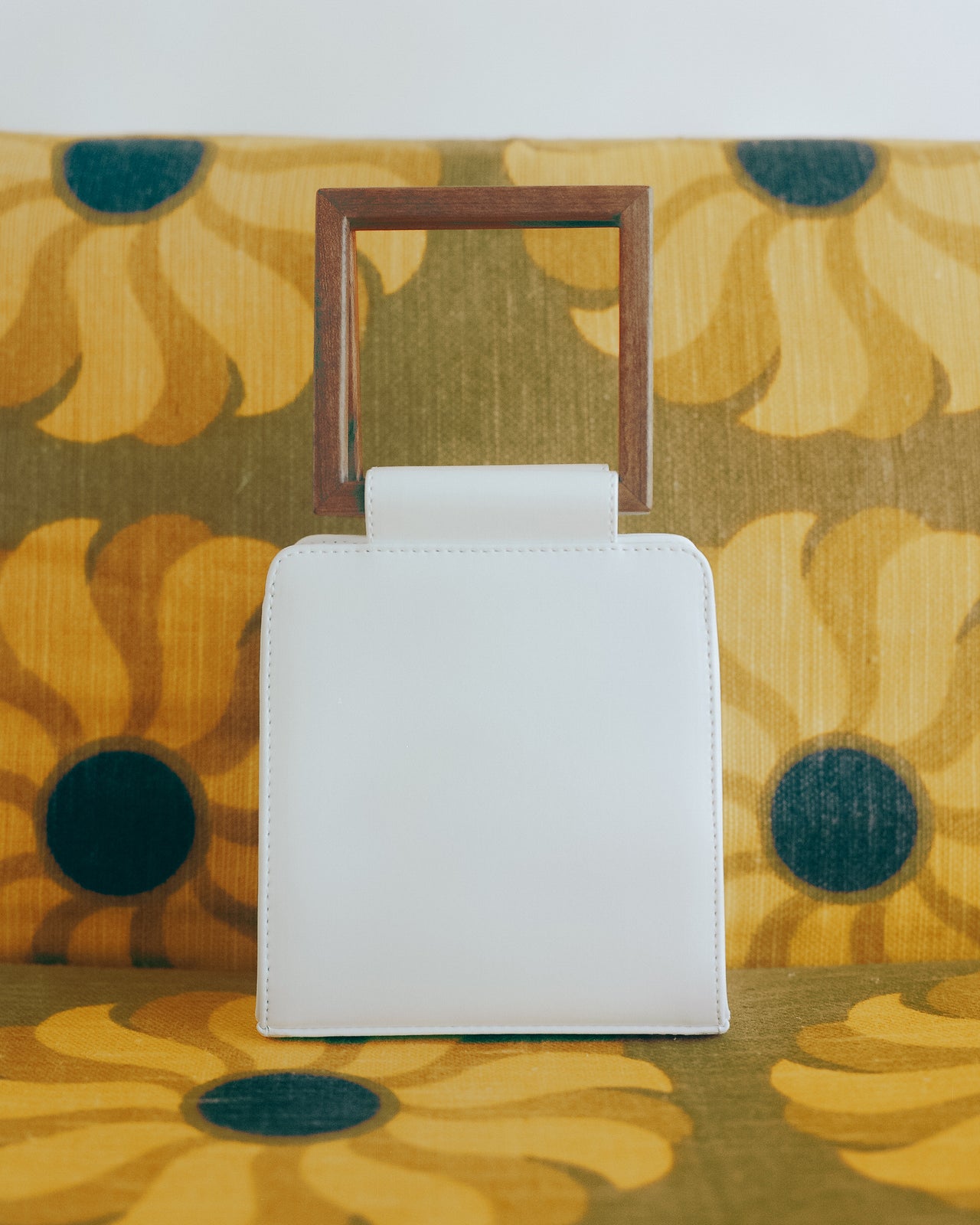 luxury handbag made from plantbased materials with a wooden handle