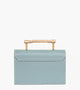 Light blue rectangular handbag with a flap closure and gold-tone bar handle.