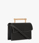 Side view of a deep black vegan handbag showcasing its refined, structured design and eco‑friendly material