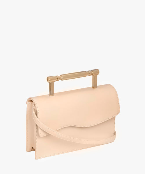 side view of creme structured bag with art-deco style gold hardware. A great vegan option for bridal.