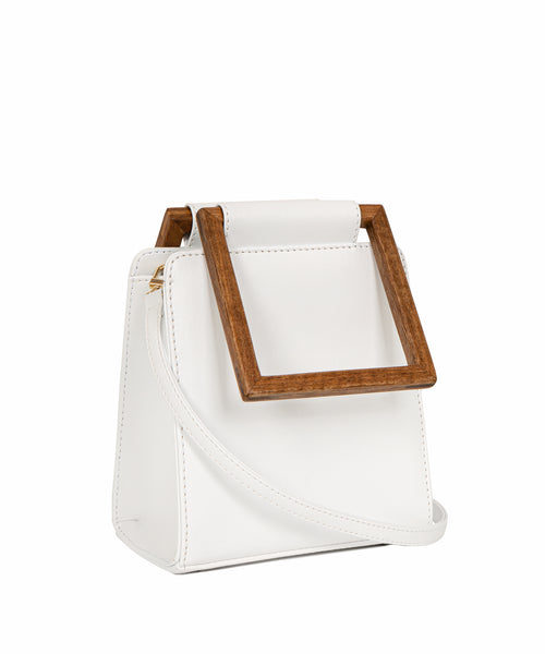 side view of a luxury handbag made from plant-based materials with wooden, re-purposed square handles