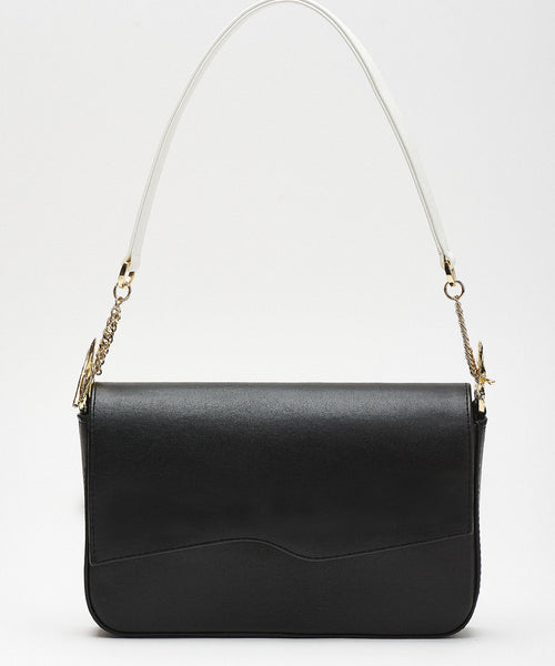Chic black shoulder bag featuring unique gold hardware and contrasting white handles, blending modern elegance with timeless sophistication.