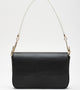 Chic black shoulder bag featuring unique gold hardware and contrasting white handles, blending modern elegance with timeless sophistication.